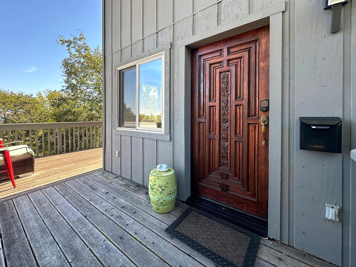 The Treehouse private red door entry on the deck